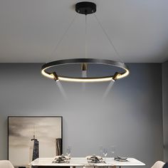 a dining room table with two chairs and a chandelier hanging from the ceiling