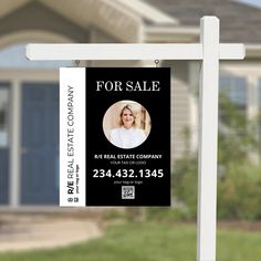 a real estate for sale sign in front of a house