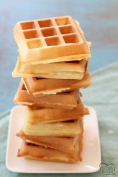 a stack of waffles sitting on top of a white plate