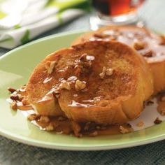 two pieces of bread on a plate with caramel sauce and pecans in the background