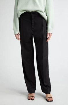 McManus's mindful approach to fashion is evident in her interpretation of classic trousers with these masterfully tailored pants cut from stretch-kissed wool. The trousers are meant to be worn low on the hips, while sharp front pleats further the fluid drape. 32" inseam; 21" leg opening; 13" front rise; 17" back rise (size 8) Zip fly with hook-and-bar closure Front slant pockets; back welt pockets 98% wool, 2% elastane Dry clean Made in the USA Designer Clothing Modern Wool Business Bottoms, Modern Formal Wool Pants, Modern Wool Formal Bottoms, Modern Wool Wide Leg Dress Pants, Modern Formal Wool Bottoms, Formal Modern Wool Bottoms, Modern Wide Leg Wool Bottoms, Modern Wool Formal Pants, Classic Wide-leg Work Pants For Formal Occasions