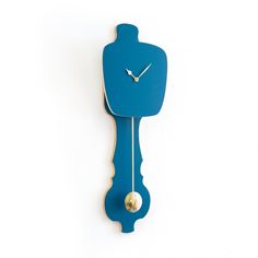 a blue clock that is on the side of a wall with a gold ball hanging from it