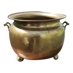 a large metal pot sitting on top of a white background