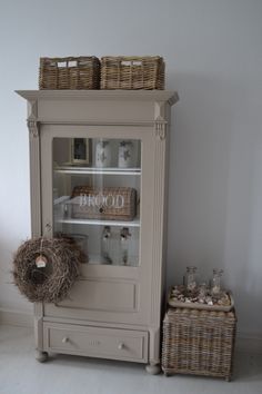 an old china cabinet with wicker baskets on top