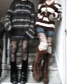 two young women standing on the steps wearing boots