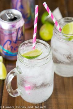 two mason jars filled with ice and limes