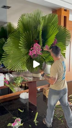 a man standing in front of a table filled with flowers