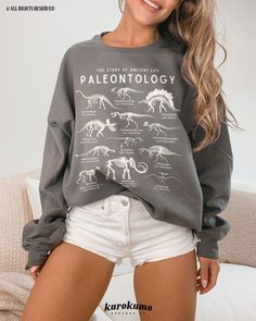 This Unisex crewneck sweatshirt features "The Study of Ancient Life | Paleontology" with a gorgeous set of vintage illustrations of dinosaurs and ancient animals. It is the perfect gift for dinosaur lovers, science teachers and present / future paleontologists! Make sure to check out the other garment options below :) » O P T I O N S « ‣ Tshirt: https://www.etsy.com/listing/1246398375 » A B O U T « ‣ This item is made to order using direct-to-garment (DTG) printing technology. This digital process involves the printer inks being jetted or sprayed onto the textile by a print head after the garment goes through a pre-treatment machine to create a stronger bond between garment fibers and the pigmented inks. ‣ This is NOT screen printed NOR do we use heat transfer vinyl (iron-on). » S I Z I N Casual Dinosaur Print Crew Neck Sweatshirt, Dark Academia Science, Dinosaur Species, Ancient Animals, Science Gifts, Vintage Illustrations, Dtg Printing, Casual Clothes, Transfer Vinyl