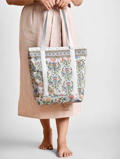 No journey is too long with the right company, and a beautiful tote handbag. Meticulously handcrafted, this gorgeous block printed tote is the perfect fun and functional accessory for life's everyday adventures. Reinforced with sturdy cotton buckram for structure, the tote is fully lined on the inside with block printed fabric, it also has two handy slip pockets inside, and one on the outside. It has a sturdy brass zip closure that is beautifully accented with a lovely, unique handmade tassel. An enchanting gift for yourself and for all the special women in your life - moms, aunts, grandmas, teachers and friends! Tote Bag With Pockets, Hand Painted Candles, Artisan Candles, Block Printed Fabric, Floral Tote Bag, Beach Tote Bag, Quilted Bedspreads, Block Printing Fabric, Functional Accessories