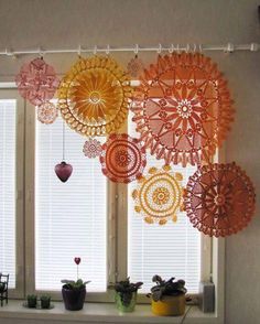 an assortment of umbrellas hanging from a window sill