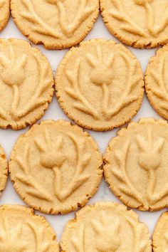 peanut butter cookies are arranged in rows on a white surface with the word love spelled out