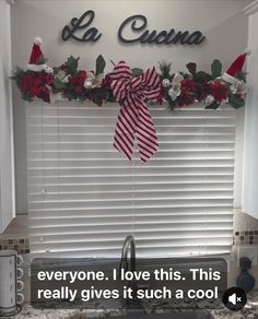 a kitchen window decorated for christmas with red and white decorations on the windowsills