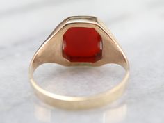 Simple and classic, this could be a great piece for a man or a woman! The style is vintage from the 1940s and has clean lines that keep the ring simple. The center is a smooth and warm carnelian, which has a lovely orange-red hue! Metal: 10K Yellow Gold Gem: Carnelian Gem Measurements: 10 x 7.8 mm, Rectangle Cushion Cut Ring Size: 8 Marks: "0K" Stamped on the inside band Orange Stone Ring, Yellow Gold Sapphire Ring, Rectangle Cushion, Demantoid Garnet, Orange Stone, Carnelian Ring, Cushion Cut Ring, Ring Simple, Cabochon Ring