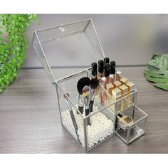 the makeup organizer is open on top of a table with cosmetics and other items in it