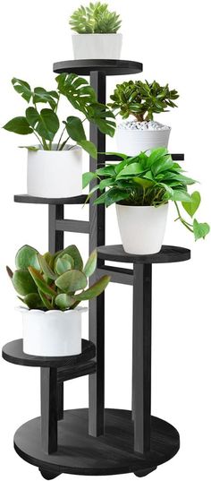 three tiered plant stand with plants in them