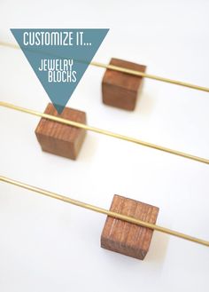 four wooden blocks are arranged on clothes pins with text overlay that says customize it jewelry blocks