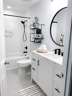 a white bathroom with black and white accessories