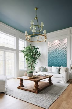 a living room filled with furniture and a potted plant on top of a table