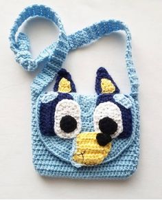 a crocheted bag with a cat face on it's front and sides