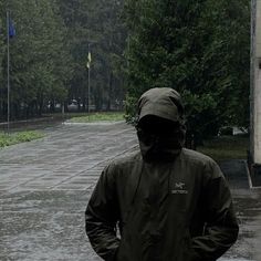 a man in a raincoat is walking down the street