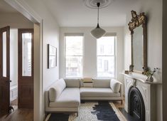 a living room filled with furniture and a fire place