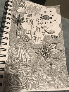 a spiral notebook with the words stay tiny little hippie written in black and white