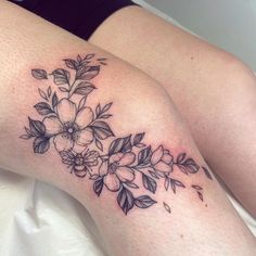 a woman's thigh with flowers on it