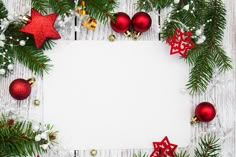 christmas decorations arranged around a white board with space in the middle for text or image