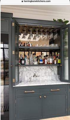 a bar with marble counter tops and cabinets