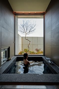 a young child is sitting in an indoor hot tub