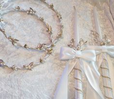 two wedding garters are laying on a white cloth with ribbons tied around them