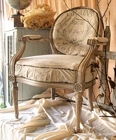 an old chair sitting in front of a window