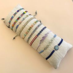 a pillow made out of bracelets on top of a table