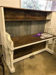 an old wooden bench with purple ribbon on it