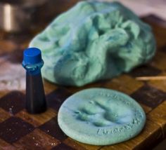 a close up of a piece of cloth on a wooden board with a blue marker