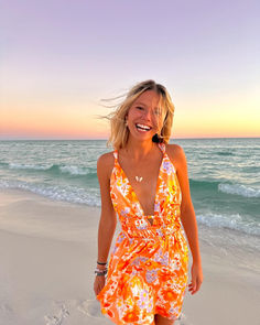 Our best selling Genovia dress now comes in a stunning orange floral print! This gorgeous mini dress looks best paired with heels and a shoulder bag to bring the WOW factor at your next cocktail event. Flirty Orange Beach Dress, Orange Summer Dresses For Holiday, Flirty Orange Floral Print Dress, Orange Floral Print Mini Dress For Vacation, Orange Floral Print Beach Dress, Orange Floral Print Dress For Beach Season, Famous Dress, Orange Floral Print, Dress Looks