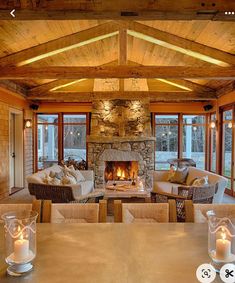 a living room filled with furniture and a fire place in the middle of a room