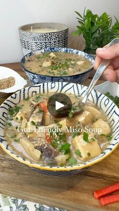 two bowls of soup on a table with carrots