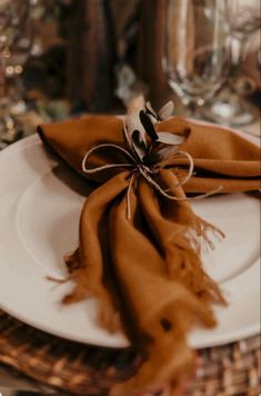 a white plate topped with a brown scarf