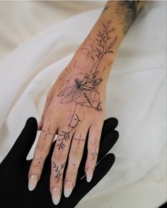 a woman's hand with tattoos on it