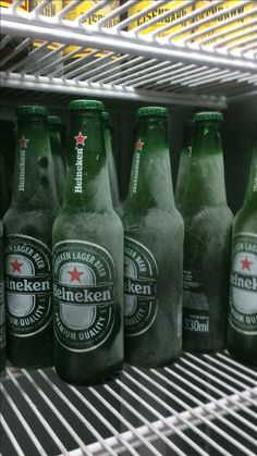 six bottles of heineken beer are on the shelf