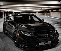 a black car parked in a parking garage