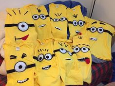 a bunch of yellow shirts that have eyes and mouths on them, sitting on a bed