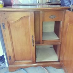 an old wooden cabinet with shelves and drawers in the process of being refinished