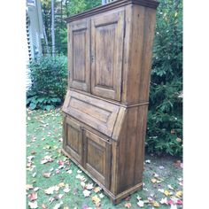 an old wooden desk sitting in the grass