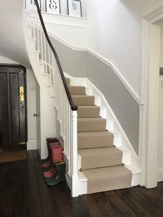 there is a set of stairs leading up to the second floor in this house with wood floors and white walls