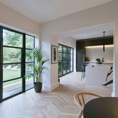 a kitchen and dining room with large windows