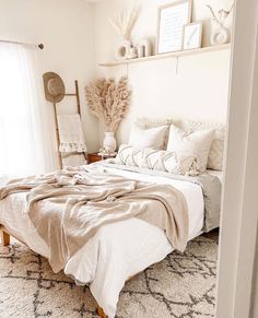 a bedroom with a bed, rugs and pictures on the wall above it's headboard