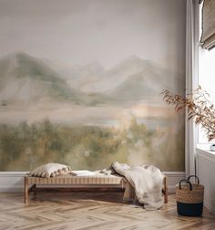 a bed sitting in front of a wall with a painting on it's side