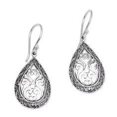 Dewa Arimbawa handcrafts these teardrop sterling silver dangle earrings. Scrolling motifs abound in this elegant design with a border of Balinese tendrils and scrolled openwork in the center. Ornate Sterling Silver Teardrop Earrings For Gift, Ornate Sterling Silver Teardrop Earrings As Gift, Ornate Sterling Silver Teardrop Filigree Earrings, Silver Teardrop Earrings With Intricate Design, Bohemian Sterling Silver Filigree Teardrop Earrings, Ornate Silver Teardrop Earrings, Ornate Silver Teardrop Pierced Earrings, Traditional Engraved Teardrop Earrings, Handmade Silver Ornate Teardrop Earrings